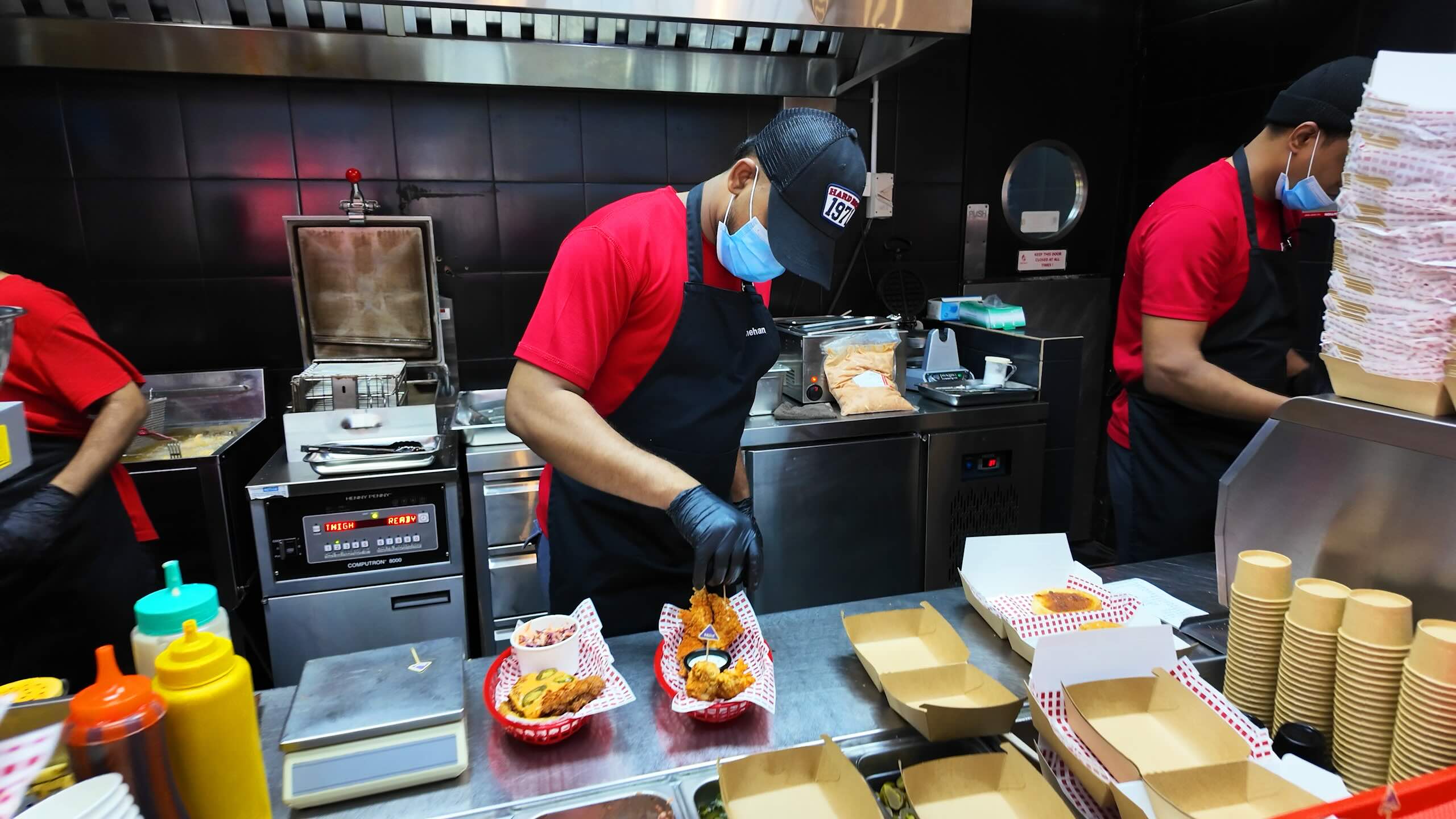 fowlboys staff working inside the kitchen preparing delicious food for the guests