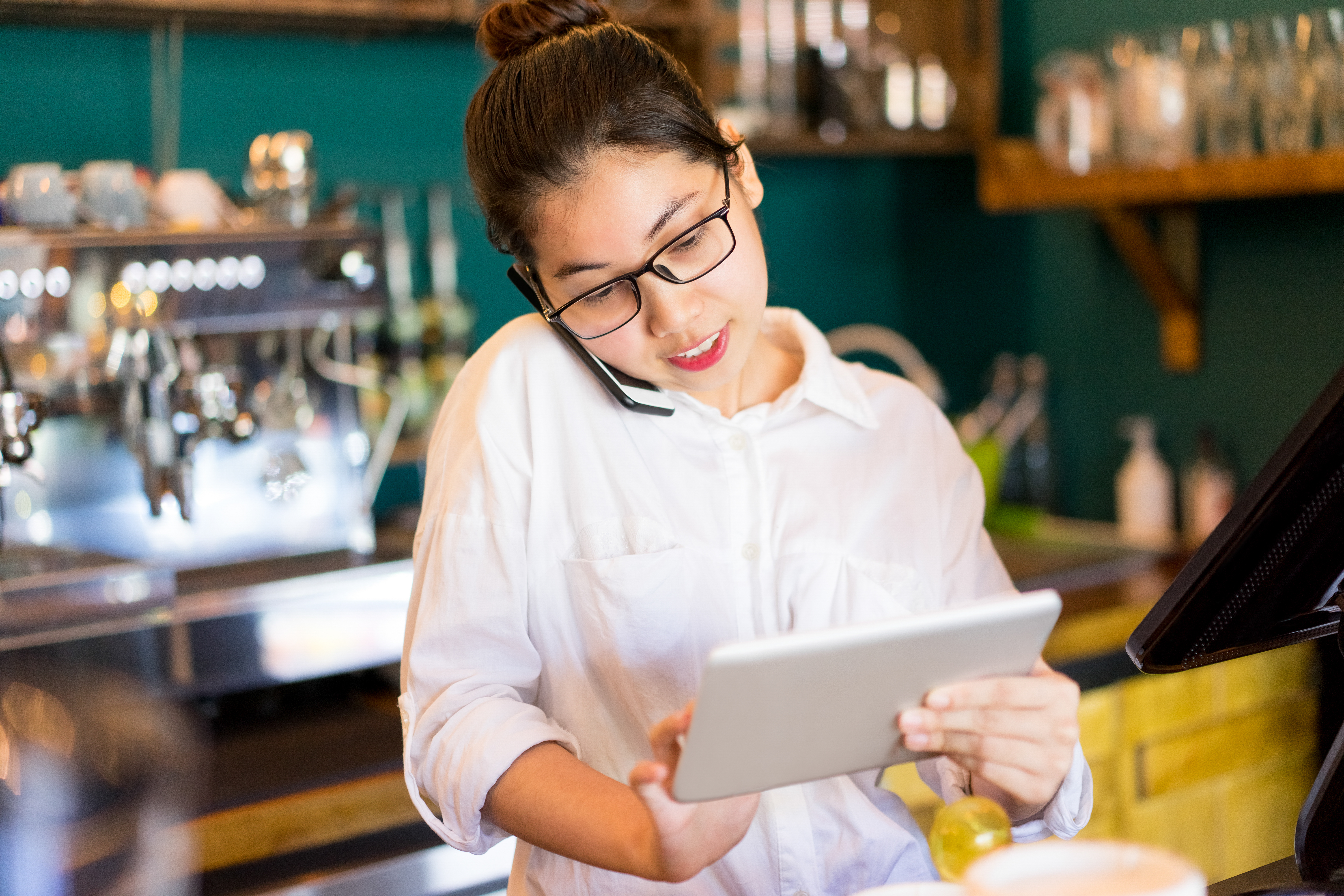 a restaurant manager adding reservation into the POS system on an iPad