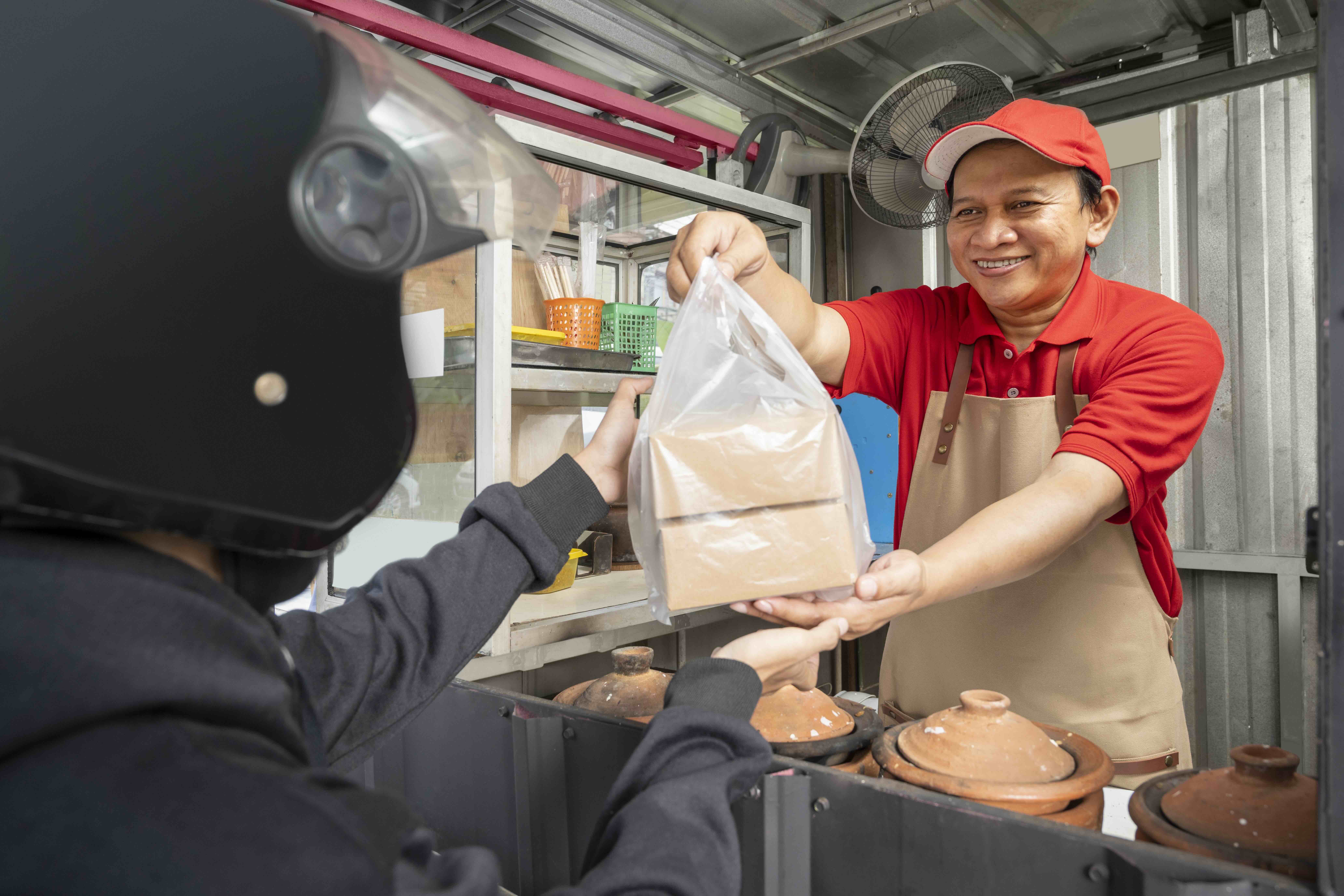 asian chef packed food for delivery