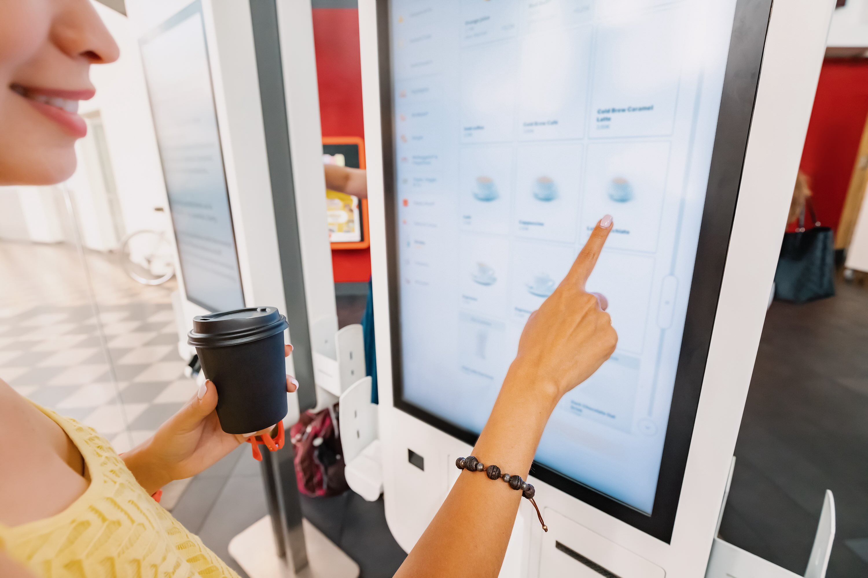 a female customer is ordering coffee from a quick service restaurant or cafe