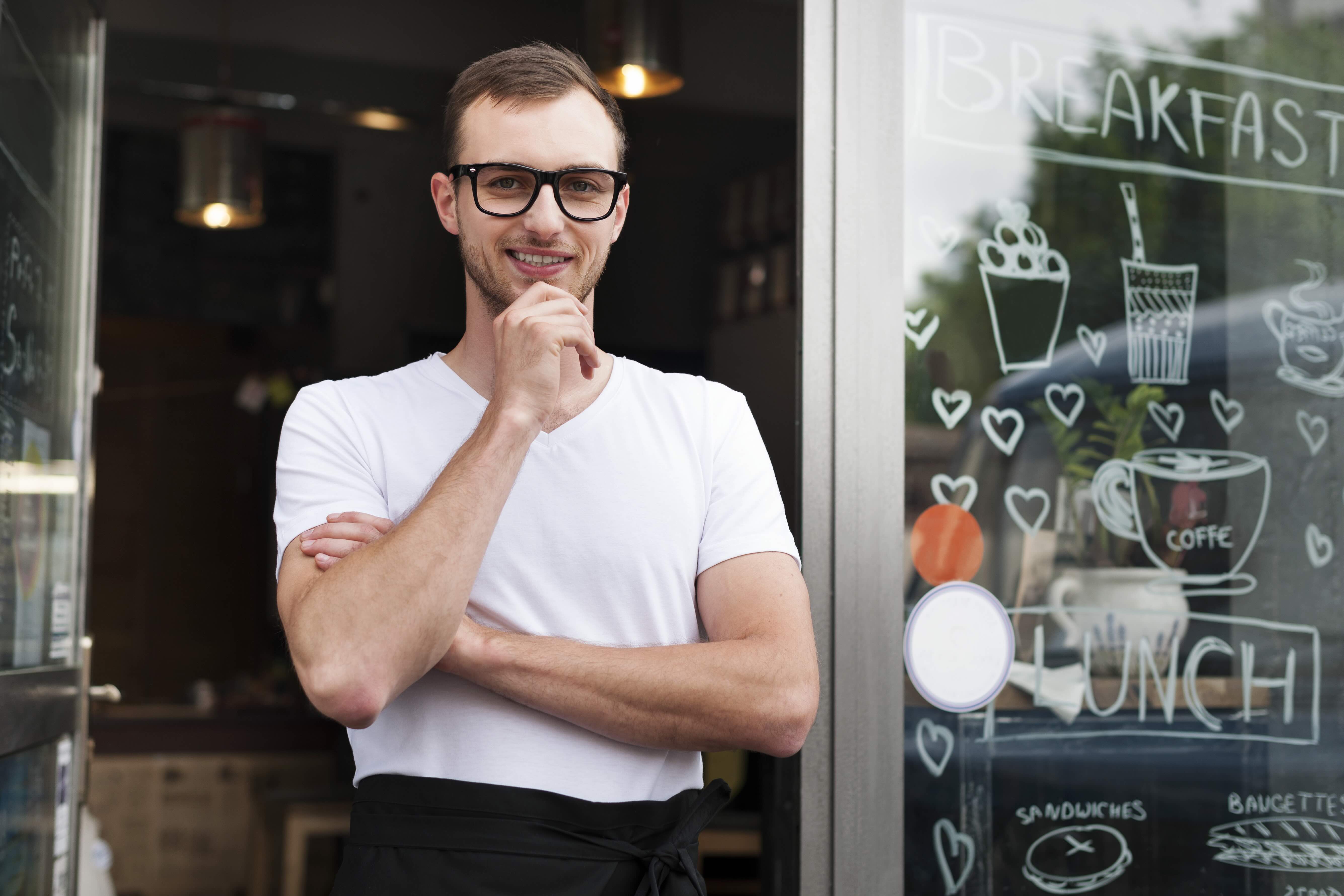 a male cafe entrepreneur smiling
