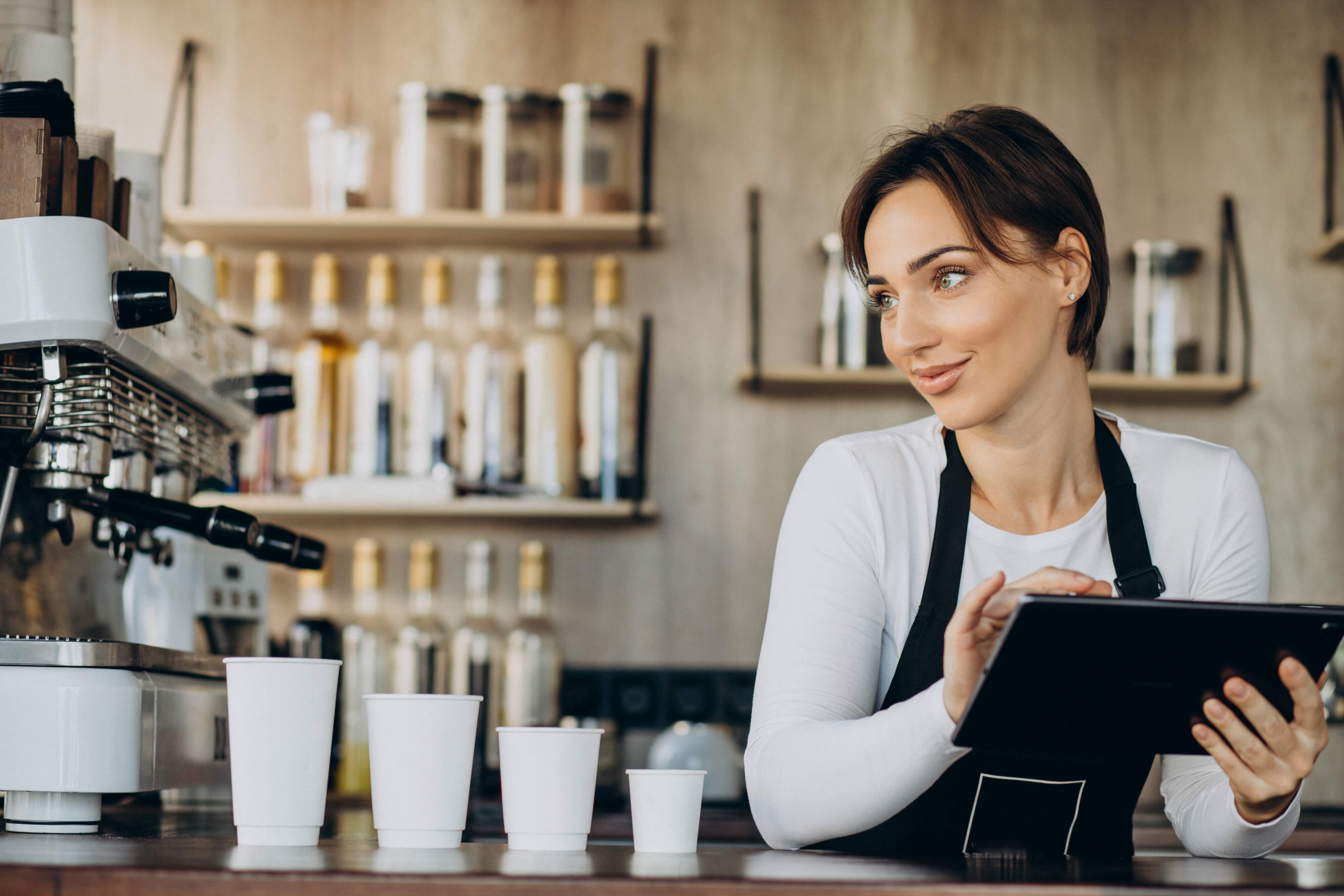 barista using pos system in a cafe or restaurant
