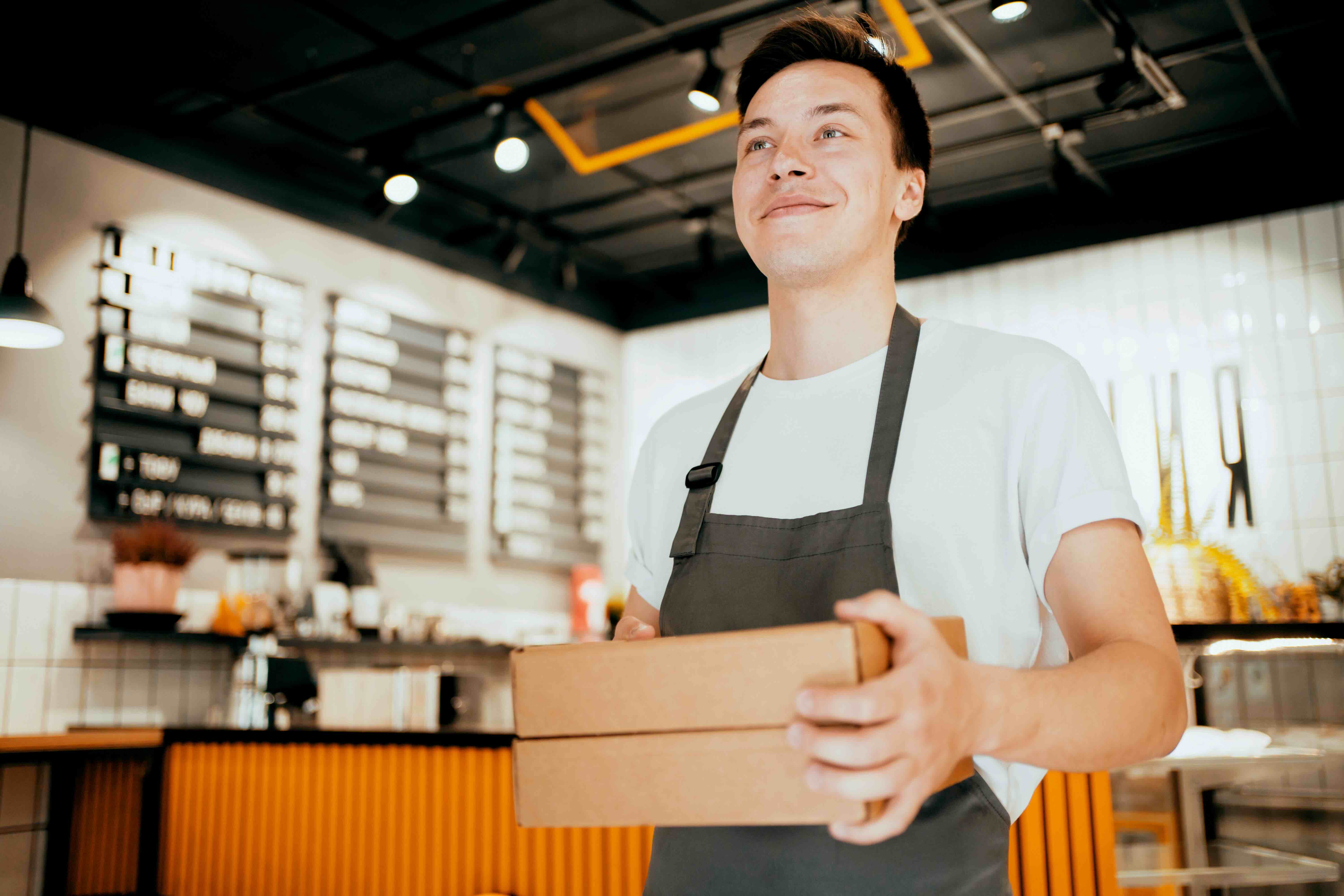 restaurant staff preparing meal for food delivery